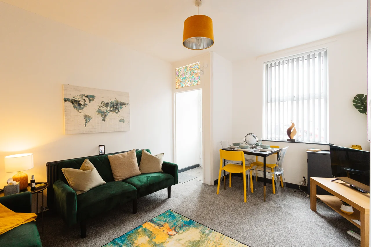 Widnes living and dining room with green sofas and yellow dining chairs