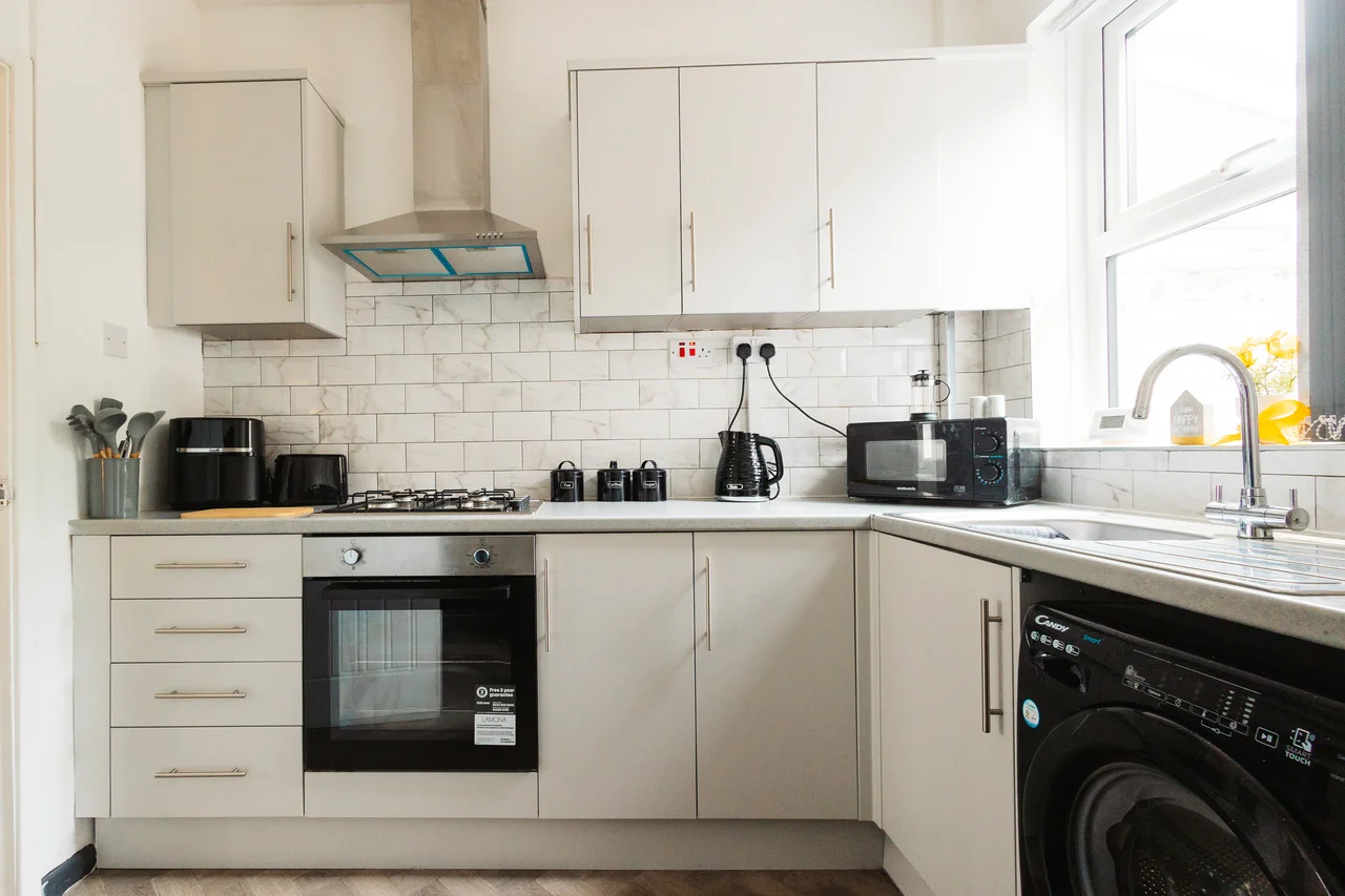 White kitchen cabinetry and worktops in the Widnes property